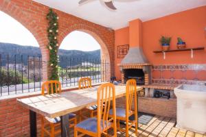 a dining room with a table and a fireplace at Villa Capital Mountainview in Carboneras