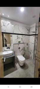 a bathroom with a toilet and a sink at Hotel Airport Fly Inn in Lucknow