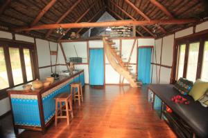 a room with a table and a staircase in a house at Cottage sur la mer in Vilanculos