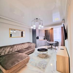 a living room with a couch and a table at VCV Apartments in Mamaia Sat/Năvodari