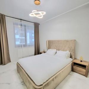 a bedroom with a large bed and a window at VCV Apartments in Mamaia Sat/Năvodari +41 photos
