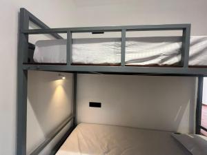 two bunk beds in a small room at Hostel Akeeka in Alleppey