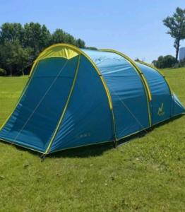 a blue tent sitting on the grass in a field at Tenda Premium Pantai Madasari in Bulakbenda