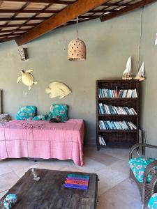 a bedroom with a bed and a book shelf at Pousada A Vida é Bela in Águas Belas