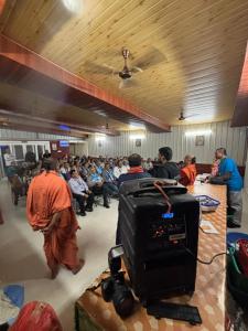 a group of people in a room with a crowd of people at Shivalik Resorts in Barkot