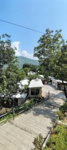 a view of a building with trees and a field at Shivalik Resorts in Barkot