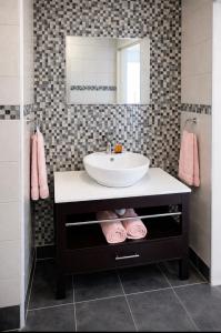 a bathroom with a sink and a mirror at Deja View in Knysna +10 photos
