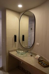 a bathroom with a glass sink and a mirror at Hotel Buena Vista in Bucaramanga +140 photos