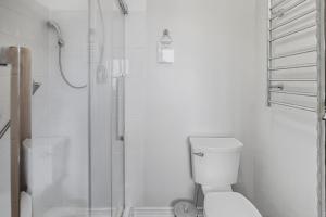 a white bathroom with a shower and a toilet at Sunset Cove AC Waterfront Kayaks in Tobermory +63 photos
