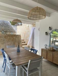 a dining room with a wooden table and chairs at Casa vacanze Madre Terra in Putignano