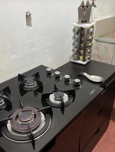 a stove top with plates and utensils on a counter at Ohmen House in Guadalajara