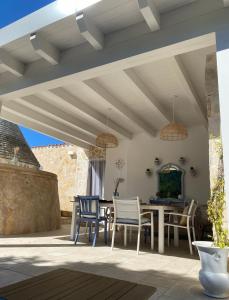 an outdoor patio with a table and chairs at Casa vacanze Madre Terra in Putignano