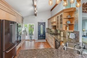 a kitchen with stainless steel appliances and wooden cabinets at Sunset Cove AC Waterfront Kayaks in Tobermory