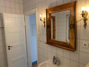 a bathroom with a sink and a mirror at Villa Art Residence Überlingen in Überlingen +52 photos