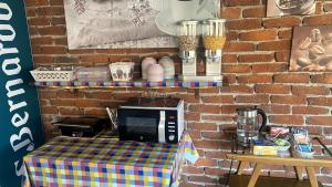 a table with a microwave on top of a brick wall at La Fornace in Garessio