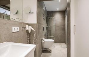 a bathroom with a shower and a toilet and a sink at Garden Suite in Binz +23 photos