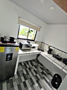 a small kitchen with a sink and a window at The Chicken House in El Castillo de La Fortuna