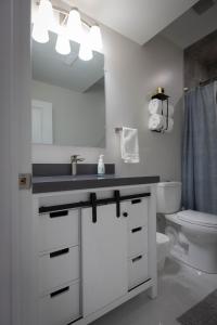 a bathroom with a sink and a toilet and a mirror at Cozy Cove Retreat, Private Suite with Separate Entrance Near Friday Harbour, Barrie & Lake Simcoe in Innisfil