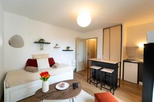 a small apartment with a bed and a small table at Le Pacé - Appartement cosy in Pacé