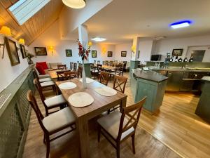 a restaurant with a table and chairs in a room at Landhotel am Mühlenwörth in Tauberbischofsheim