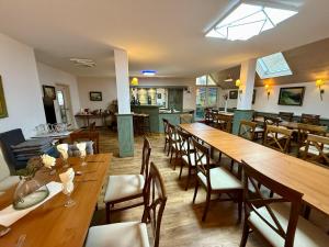 a dining room with wooden tables and chairs at Landhotel am Mühlenwörth in Tauberbischofsheim +33 photos