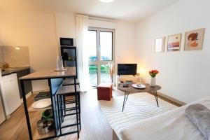 a living room with a couch and a table at Le Pacé - Appartement cosy in Pacé