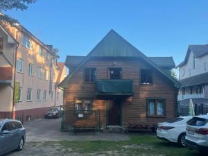 a wooden house in the middle of a street at PanTuszka Pokoje in Pobierowo