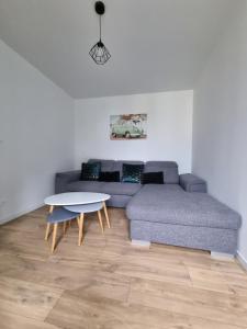 a living room with a couch and a table at Gîte 6 personnes Chez Max in Nébouzat