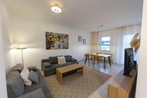 a living room with a couch and a table at Ferienwohnung Allegra in Heinsberg