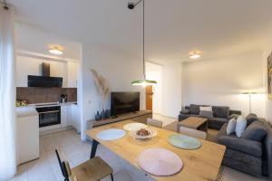 a living room with a table and a couch at Ferienwohnung Allegra in Heinsberg