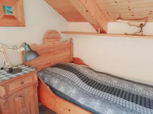 a bedroom with a bed and a desk with a lamp at Enzian in Sesto
