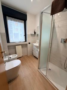 a bathroom with a shower and a toilet and a sink at Melannie's Apartment in Bergamo +68 photos