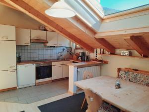 a kitchen with a wooden table and a ceiling at Enzian in Sesto