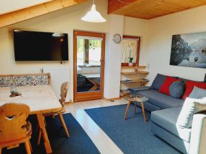 a living room with a couch and a table at Enzian in Sesto