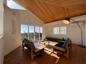 a living room with two chairs and a table at Smile House Akiya in Hayama