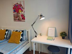 a bedroom with a desk and a bed with a desk and a lamp at Comfort flat with great location in Prague