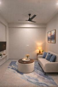 a living room with a couch and a table at Chèrie Blueleaf in Jaipur