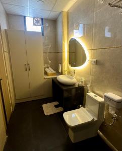 a bathroom with a toilet and a sink and a mirror at Chèrie Blueleaf in Jaipur +19 photos