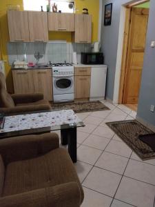 a kitchen with a couch and a table in a room at Zacisze Sokolec in Ludwikowice Kłodzkie +2 photos