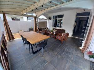 a patio with a wooden table and chairs at LA MAGDALENA in Arsenal