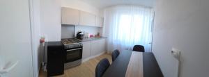 a small kitchen with a table and a stove top oven at Shakespeare Central Apartment in Craiova +13 photos