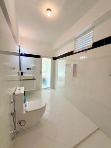 a white bathroom with a tub and a sink at Moringa Beach in Mirissa +66 photos