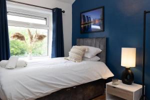 a bedroom with a large bed with a window at The Standhouse Radcliffe in Radcliffe