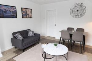 a living room with a couch and a table at The Standhouse Radcliffe in Radcliffe