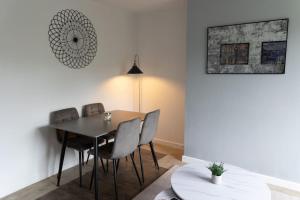 a dining room with a table and chairs at The Standhouse Radcliffe in Radcliffe +5 photos