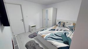 a small bedroom with a bed and a mirror at Moonriver Alps Ski Apartament in Ramingstein