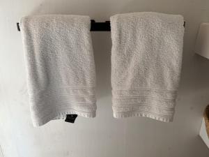 two towels hanging on a towel rack in a bathroom at R&M Boutique in Lijnden +186 photos