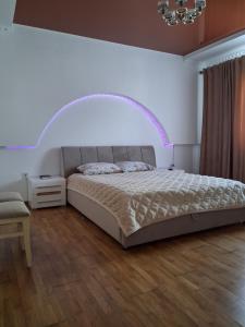 a bedroom with a large bed with a white wall at MODEST in Slavske +31 photos