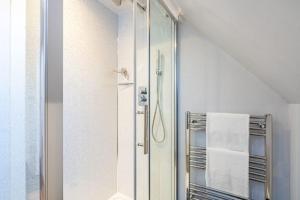 a bathroom with a shower with a glass door at Lonan Country House and Gardens in Taynuilt +61 photos