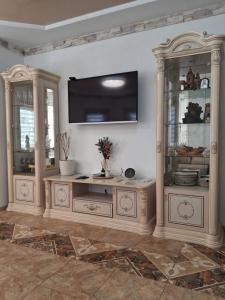 a living room with a tv on a wall at MODEST in Slavske